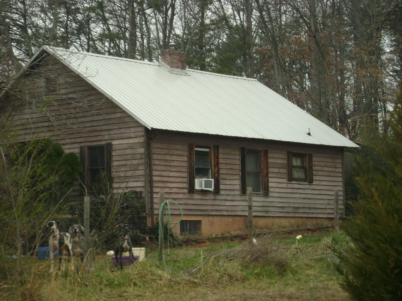 White metal roof on an old wood sided farmhouse, from a Metal Roof Installation job in Fairmont